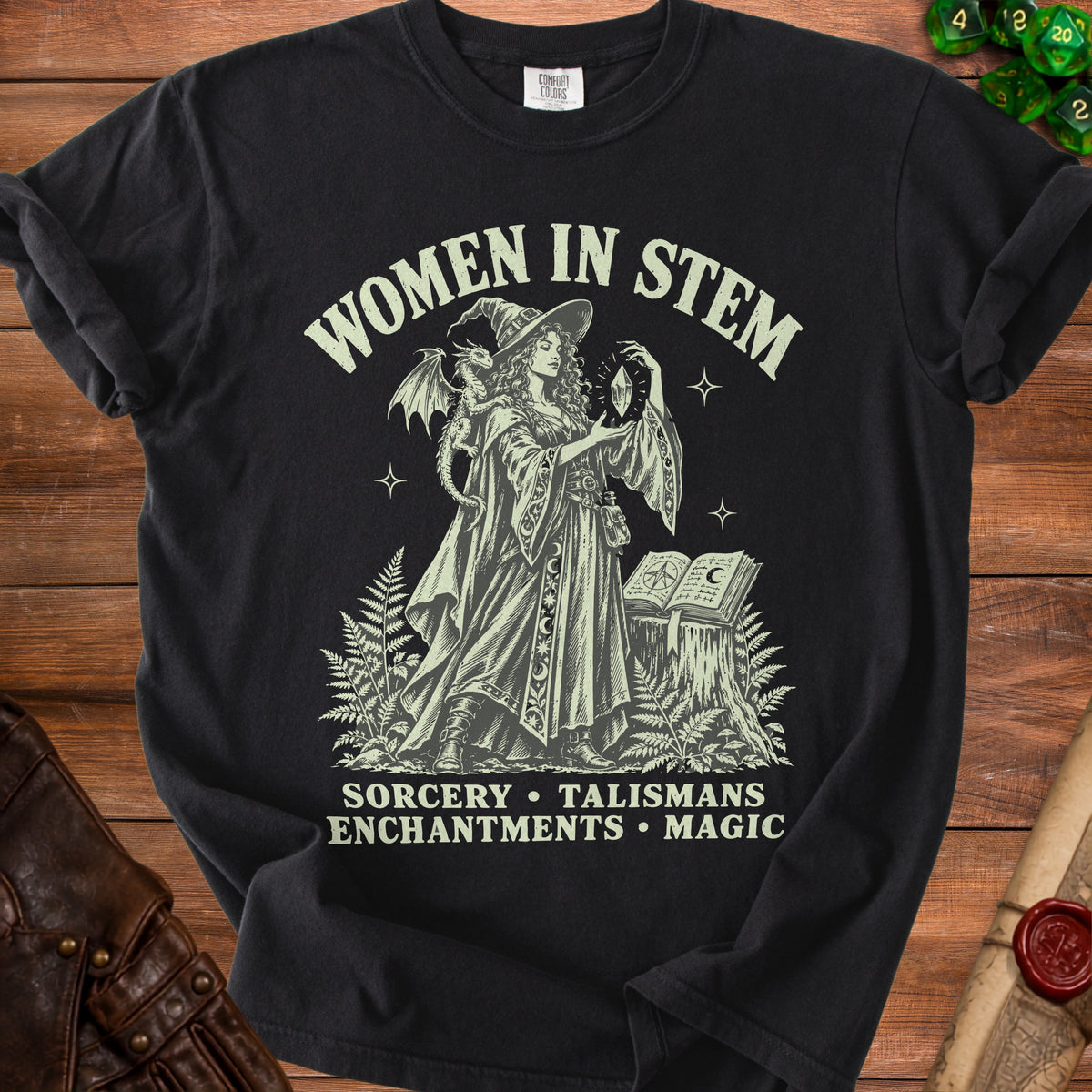 Black t-shirt with "Women in STEM" text and a sorceress with a dragon.