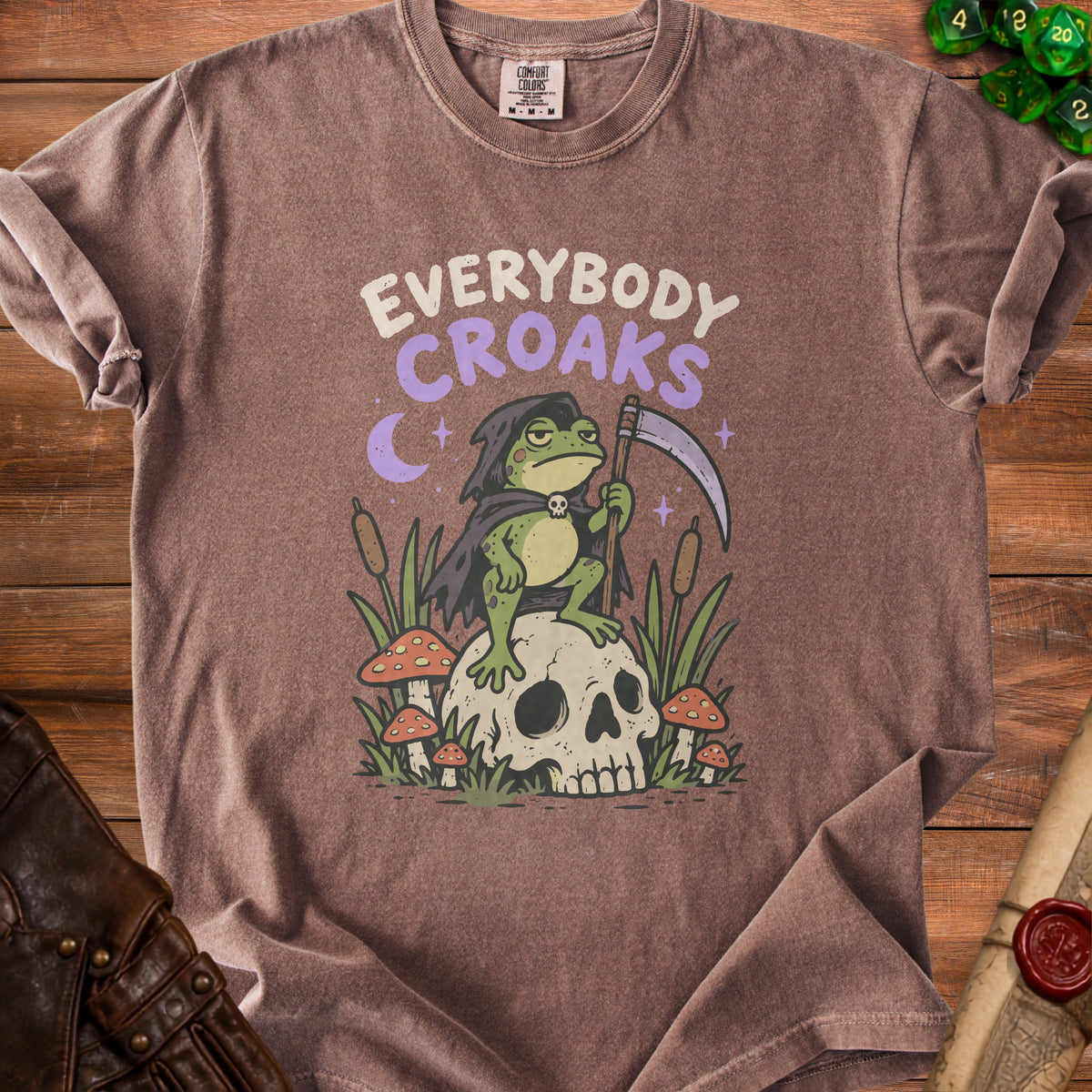 Brown t-shirt with a grim reaper frog sitting on a skull, text "EVERYBODY CROAKS".