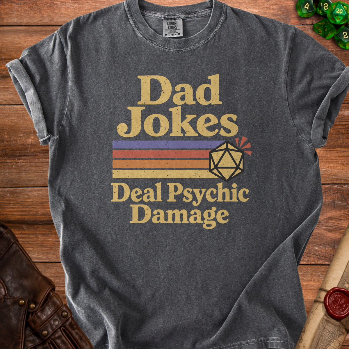 Dark gray t-shirt with text "Dad Jokes Deal Psychic Damage" and a d20 die.
