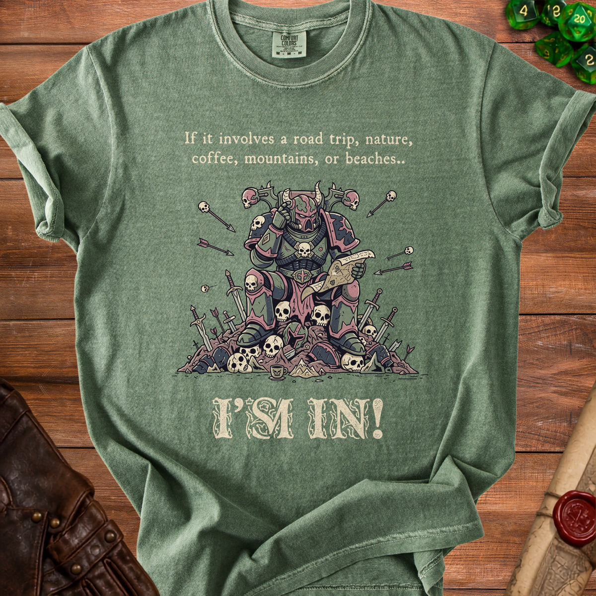 Green t-shirt with illustration of armored figure reading a map among skulls and swords.