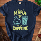 Navy t-shirt with "low MANA & high CAFFEINE" text and graphics.