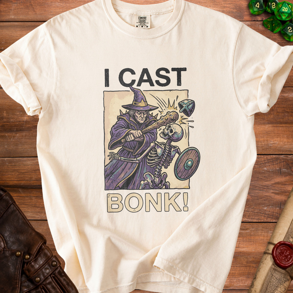 Cream t-shirt with wizard, skeleton, and text "I CAST BONK!".