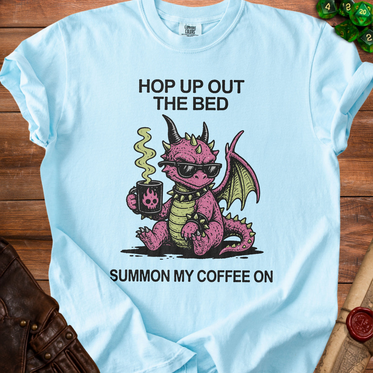 Light blue t-shirt with pink dragon graphic and text "Hop Up Out The Bed Summon My Coffee On".
