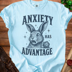 Light blue t-shirt with "ANXIETY HAS ADVANTAGE" text and a rabbit with a D20 die.