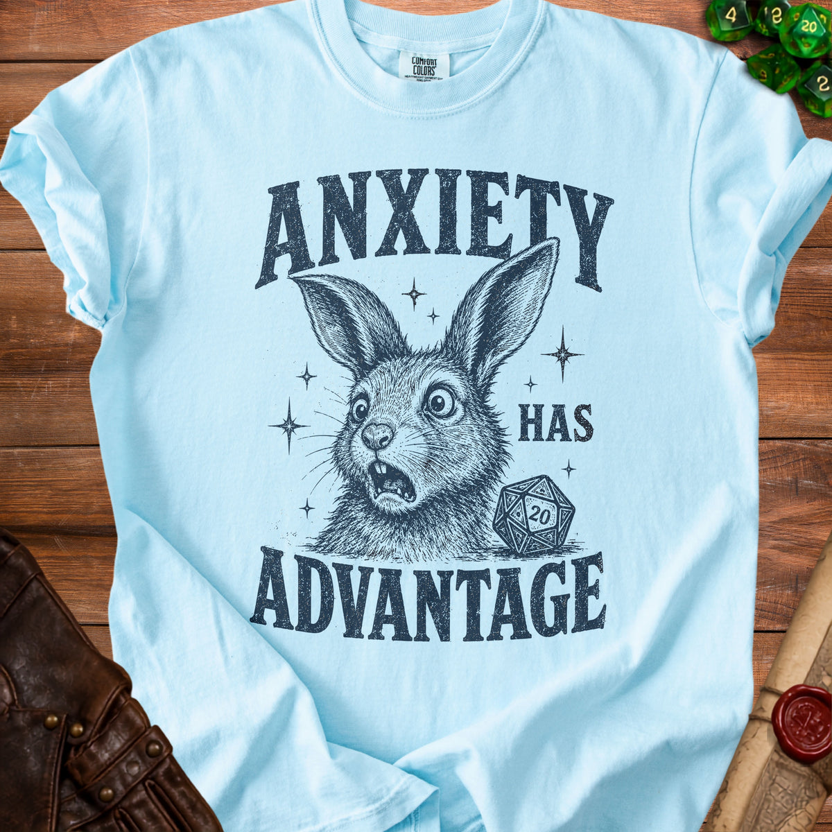 Light blue t-shirt with "ANXIETY HAS ADVANTAGE" text and a rabbit with a D20 die.