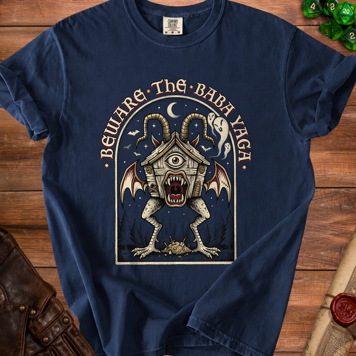 Navy t-shirt with "Beware The Baba Yaga" text and a spooky hut monster illustration.