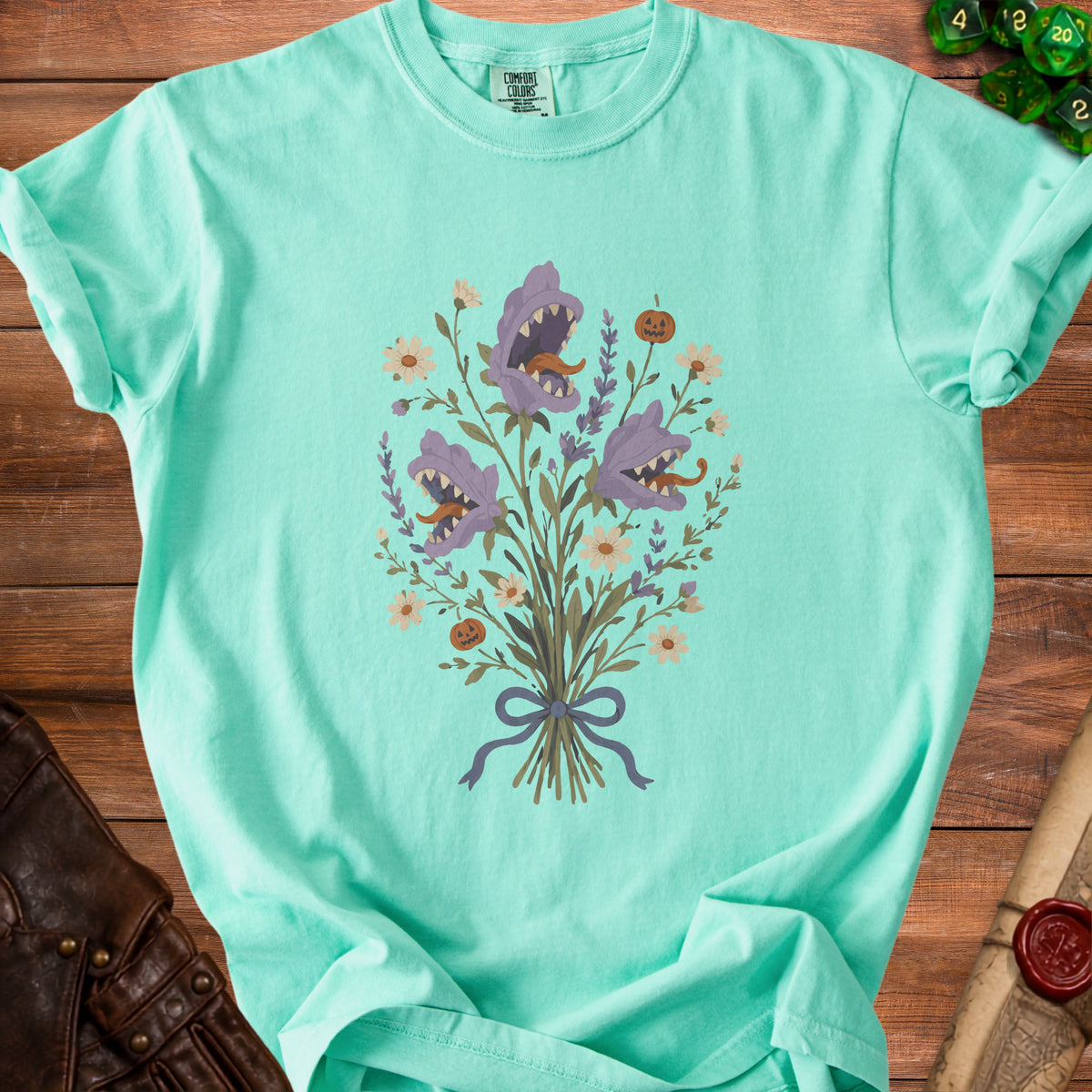 Aqua t-shirt with a floral bouquet of carnivorous plants and a jack-o-lantern.