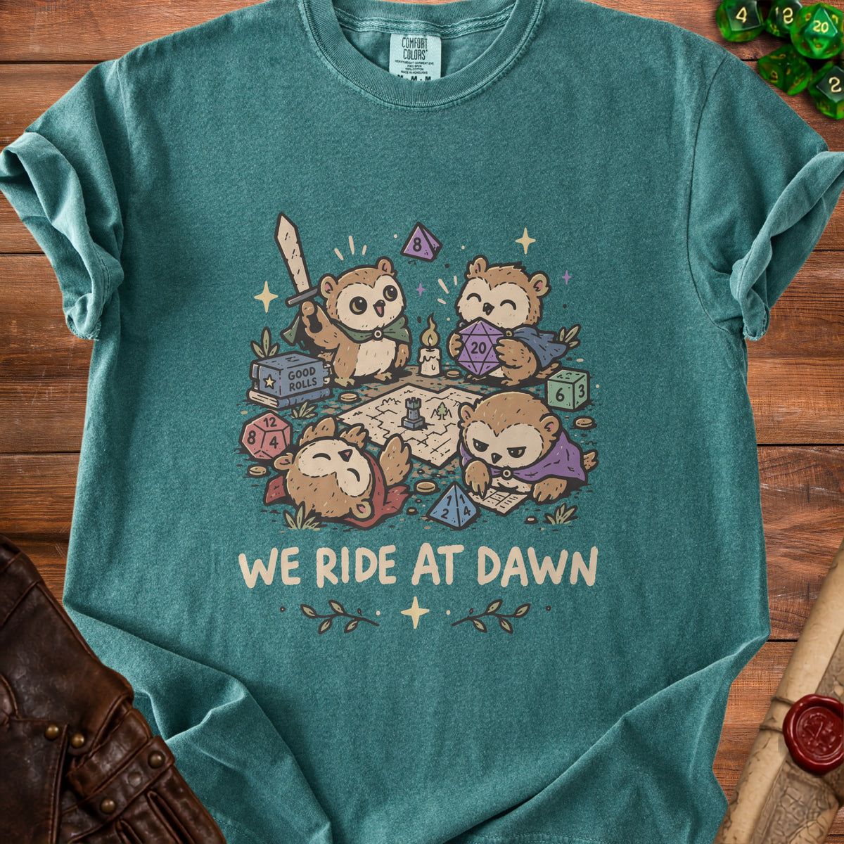 Owl characters playing tabletop RPG with dice, map, and sword, text "WE RIDE AT DAWN".