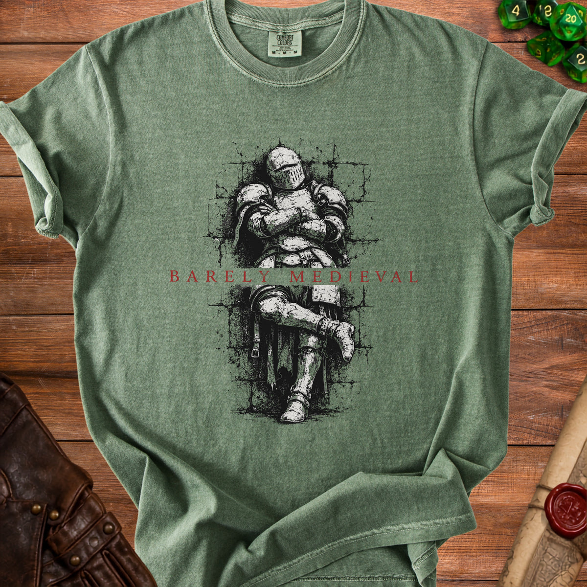 Green t-shirt with a drawing of a knight and text "BARELY MEDIEVAL".