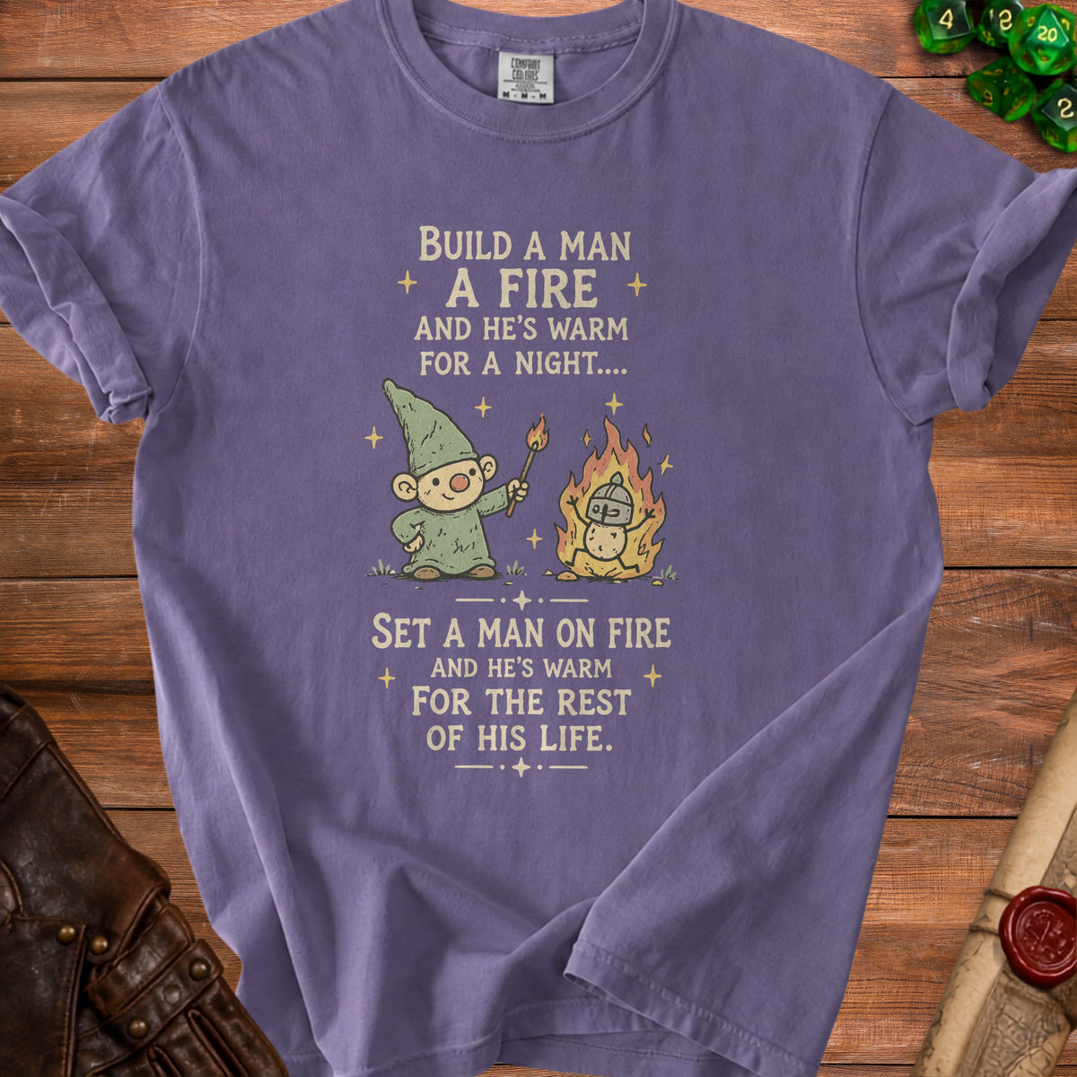 Purple t-shirt with gnome lighting a man on fire, text: "Set a man on fire and he's warm for the rest of his life."
