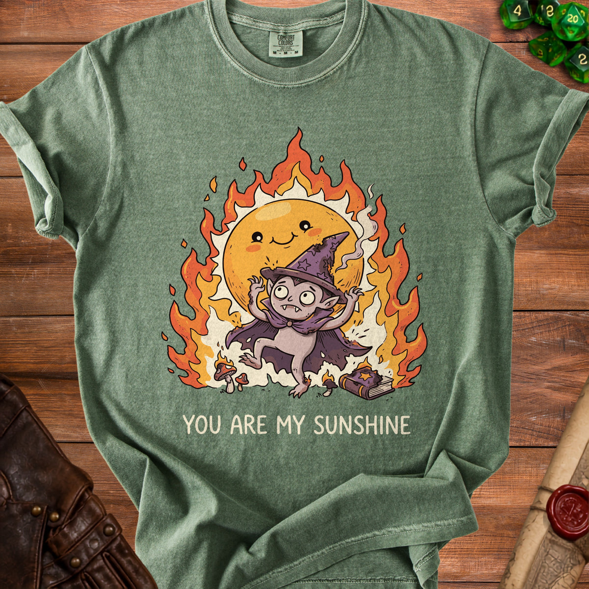 Green t-shirt with a cartoon vampire and flaming sun graphic and text.