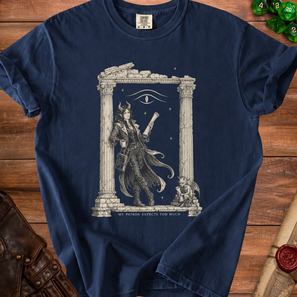 Navy t-shirt with illustration of a horned woman, eye, and text "MY PATRON EXPECTS TOO MUCH".