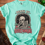 Aqua t-shirt with a skeleton graphic and the text "DEATH BY OVERTHINKING".
