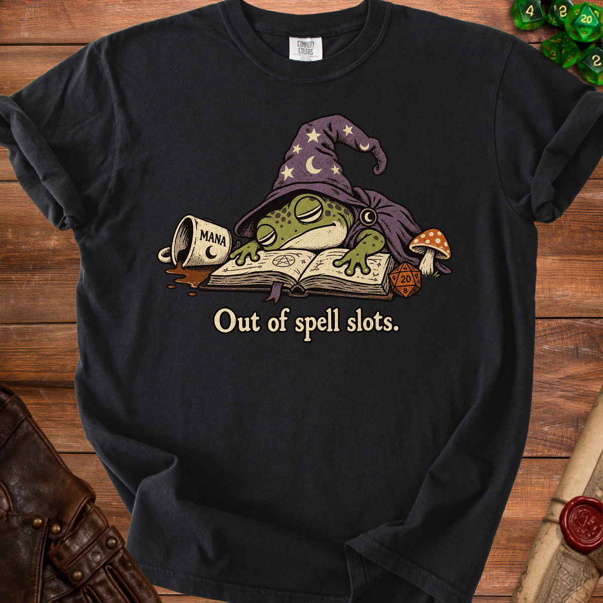 Black t-shirt with a wizard frog sleeping on a spellbook, text reads "Out of spell slots."