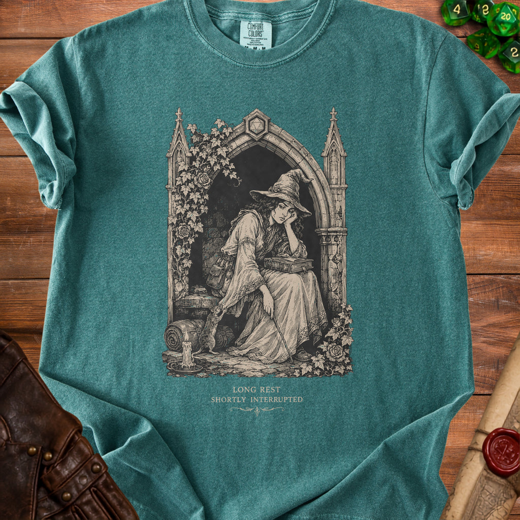 Green t-shirt with a gothic art print of a tired witch reading and a rat.