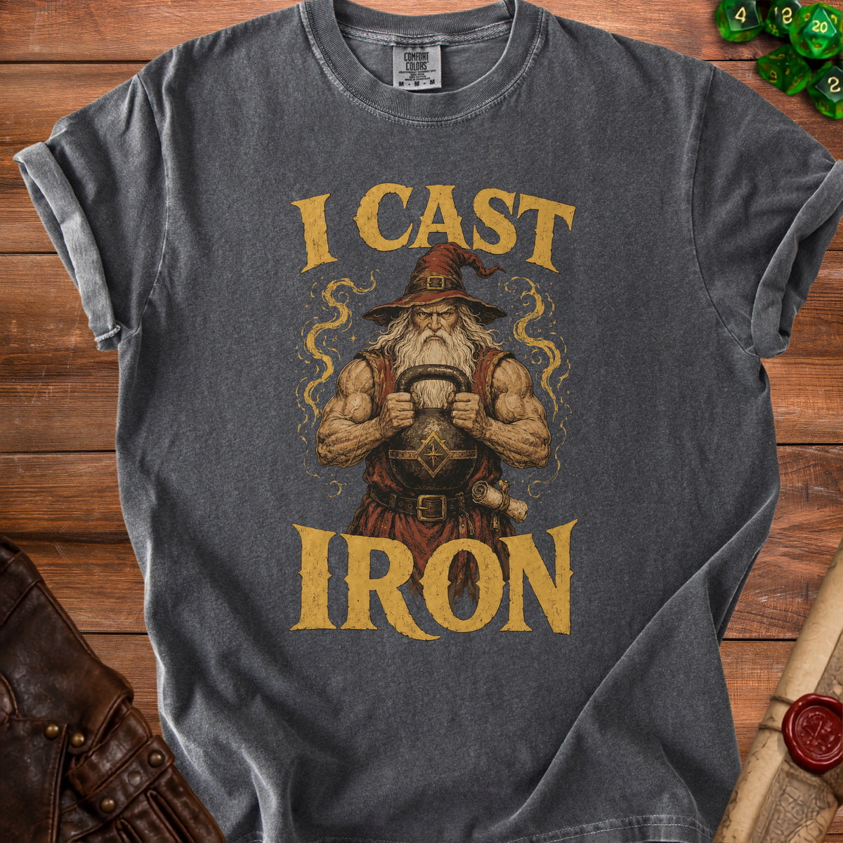 Dark grey t-shirt with graphic of muscular wizard holding kettlebell, text says "I CAST IRON".