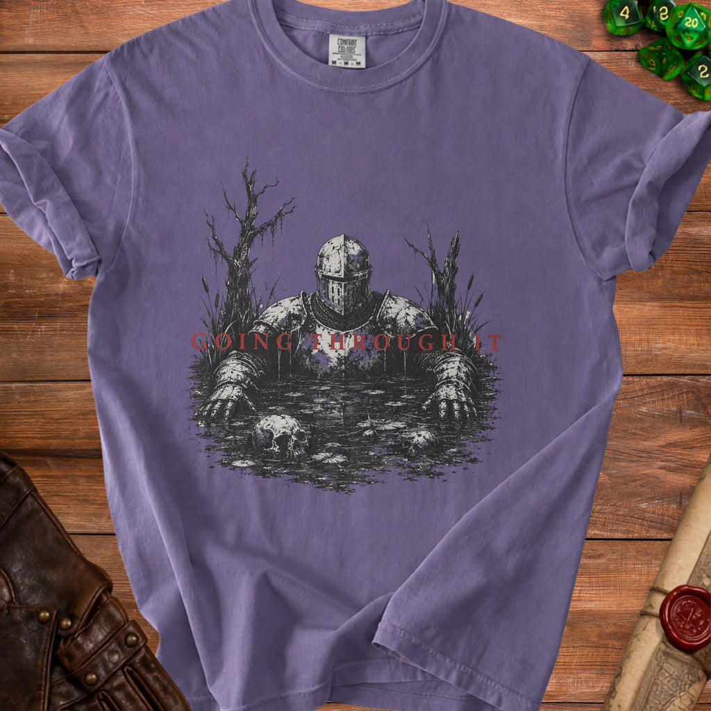 Purple t-shirt with knight in swamp graphic and text "GOING THROUGH IT."