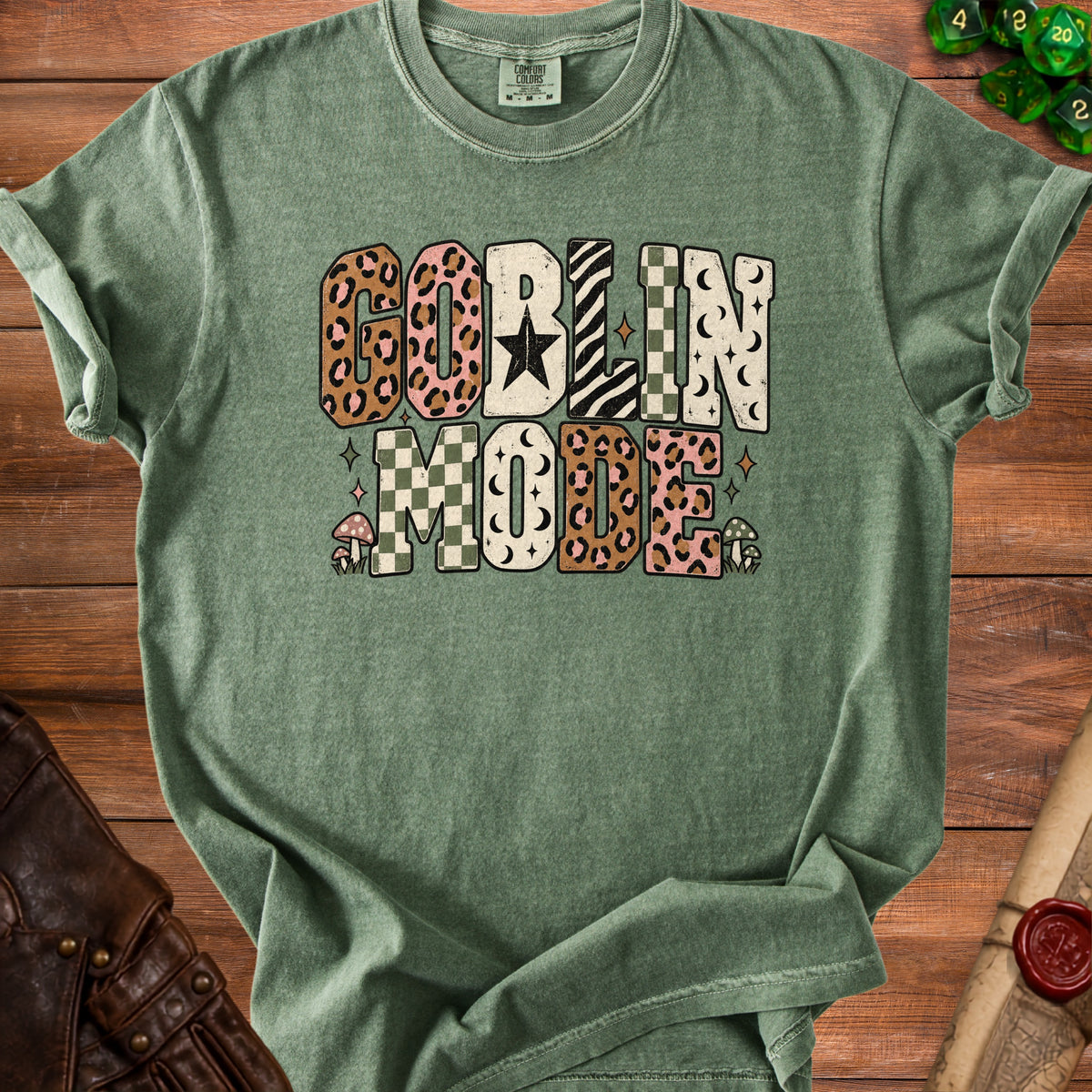 Green t-shirt with "Goblin Mode" text in various patterns and mushroom accents.
