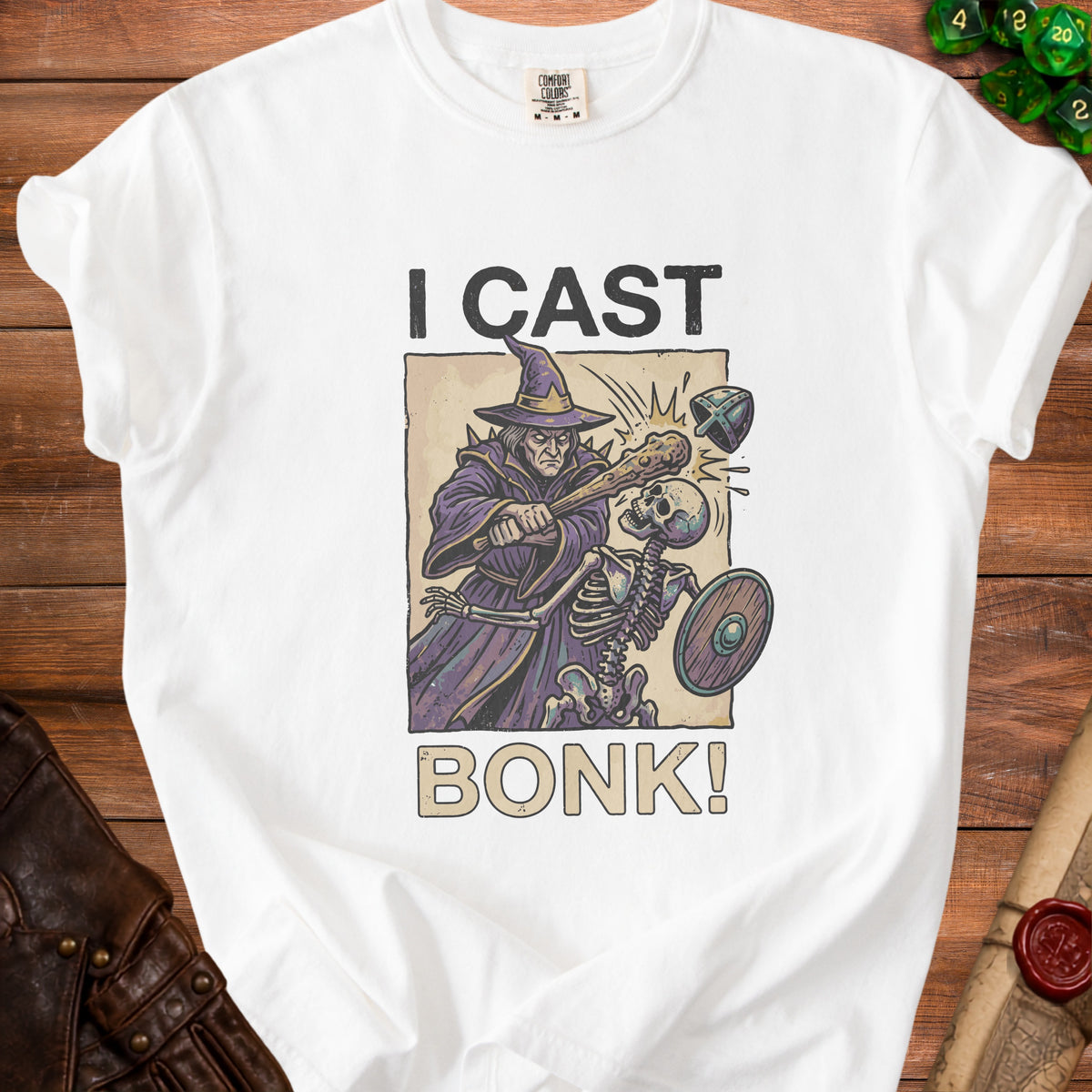 White t-shirt with "I CAST BONK!" text and a wizard attacking a skeleton graphic.