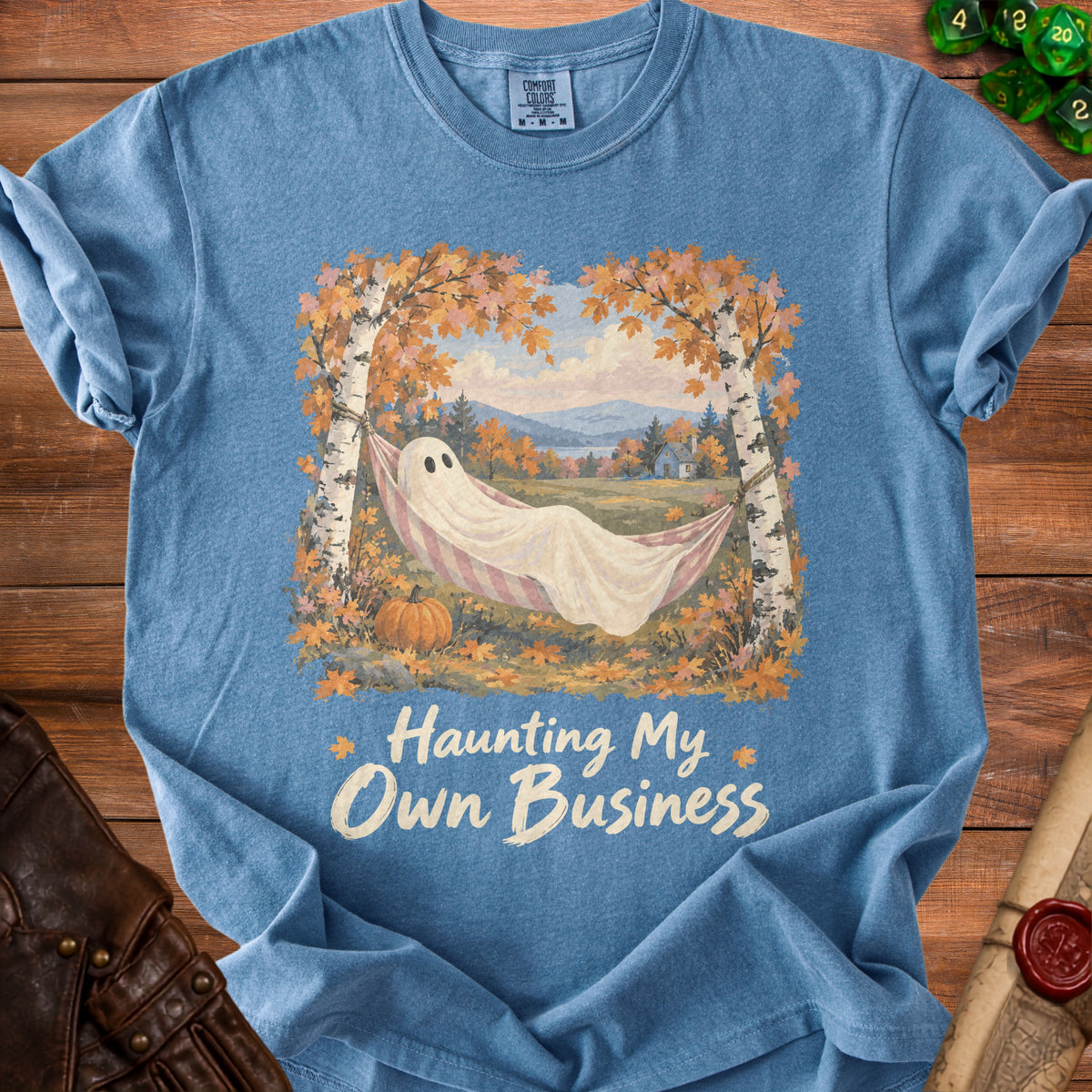 Blue t-shirt with ghost in hammock and text "Haunting My Own Business".