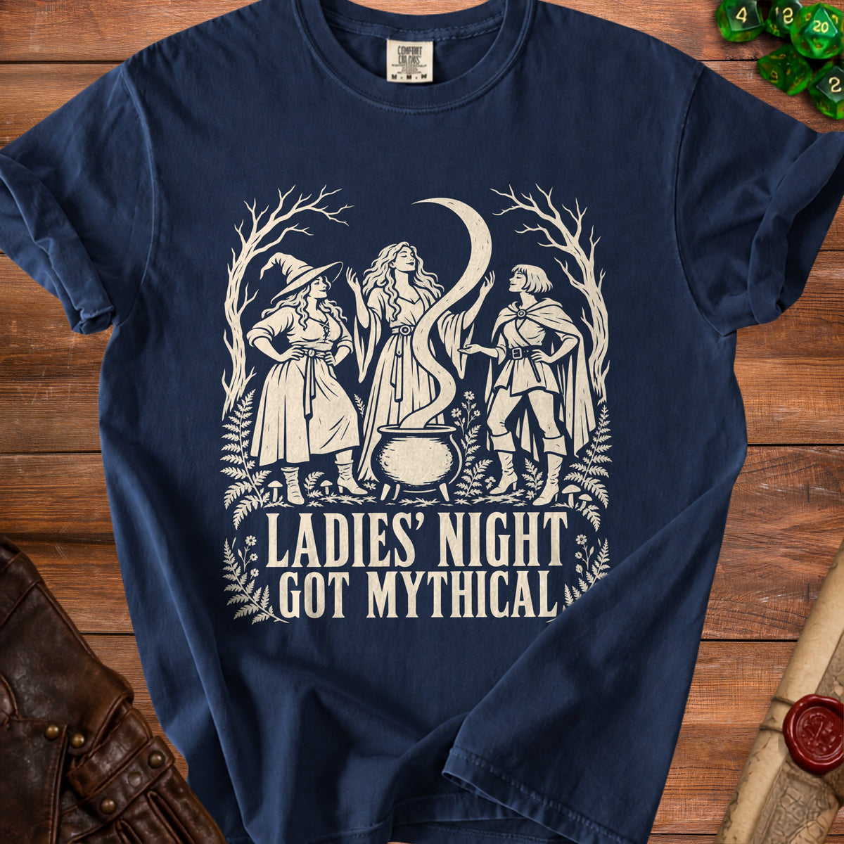 Navy t-shirt with white graphic of three women, cauldron, moon, and text "LADIES' NIGHT GOT MYTHICAL".