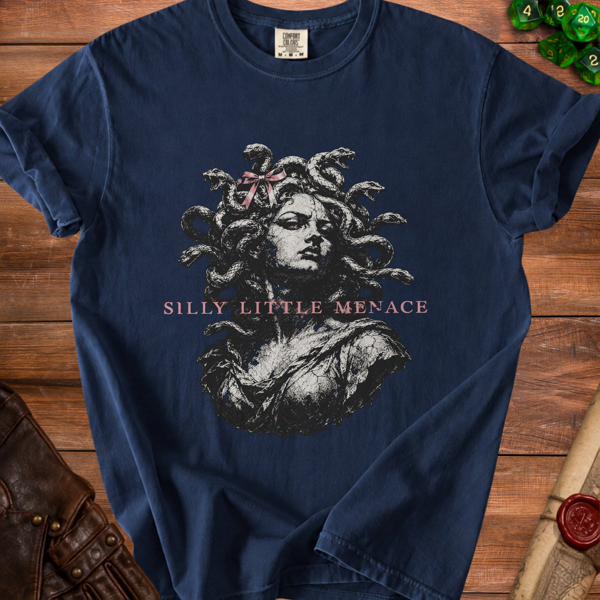 Navy t-shirt with a distressed print of Medusa and the text "Silly Little Menace".