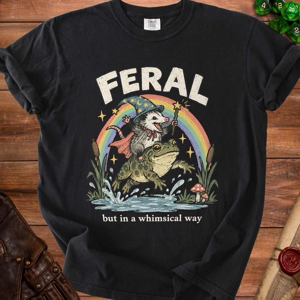 "Feral" t-shirt with opossum wizard riding a frog over a rainbow.
