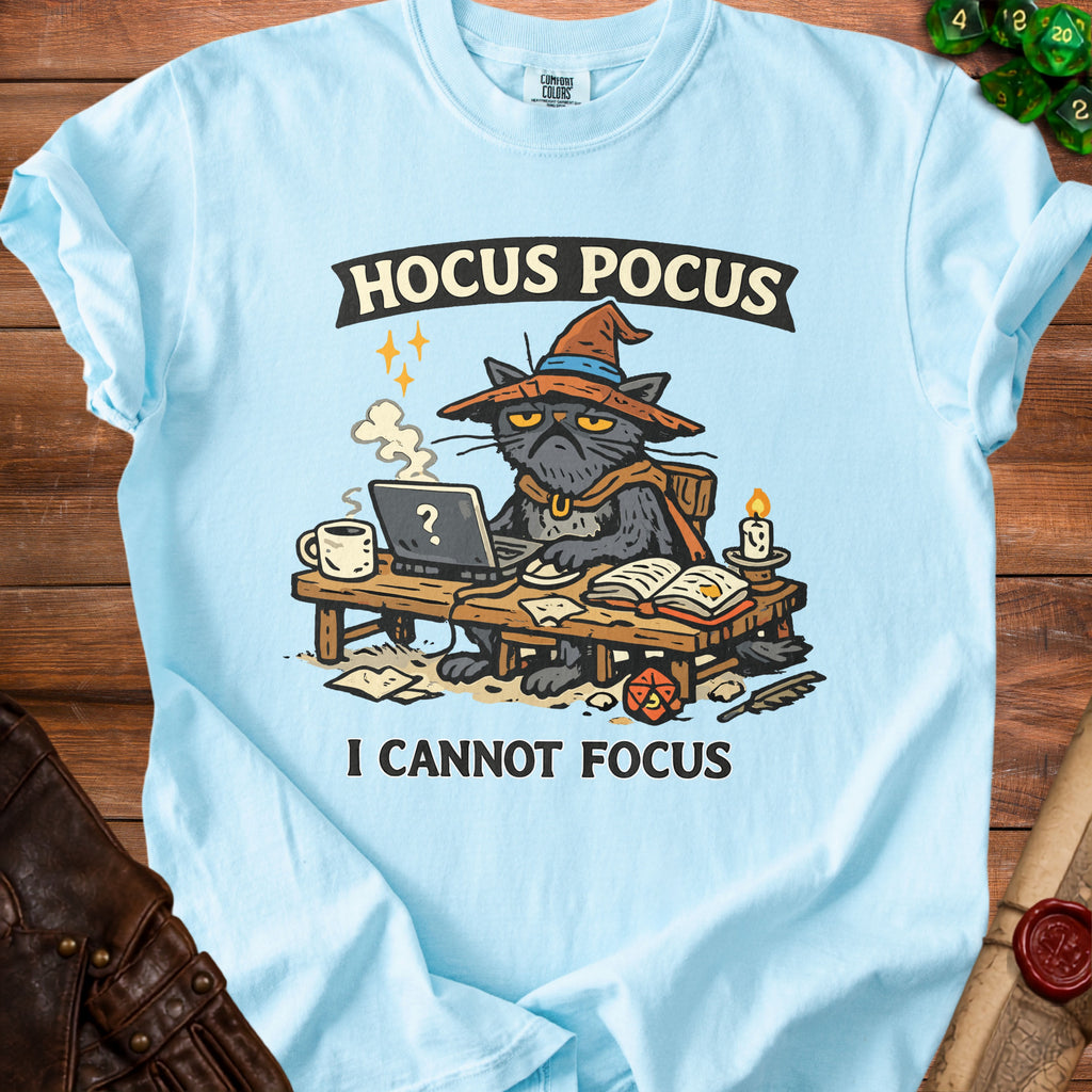 Light blue t-shirt with a grumpy black cat wearing a witch hat, "HOCUS POCUS" and "I CANNOT FOCUS" text.
