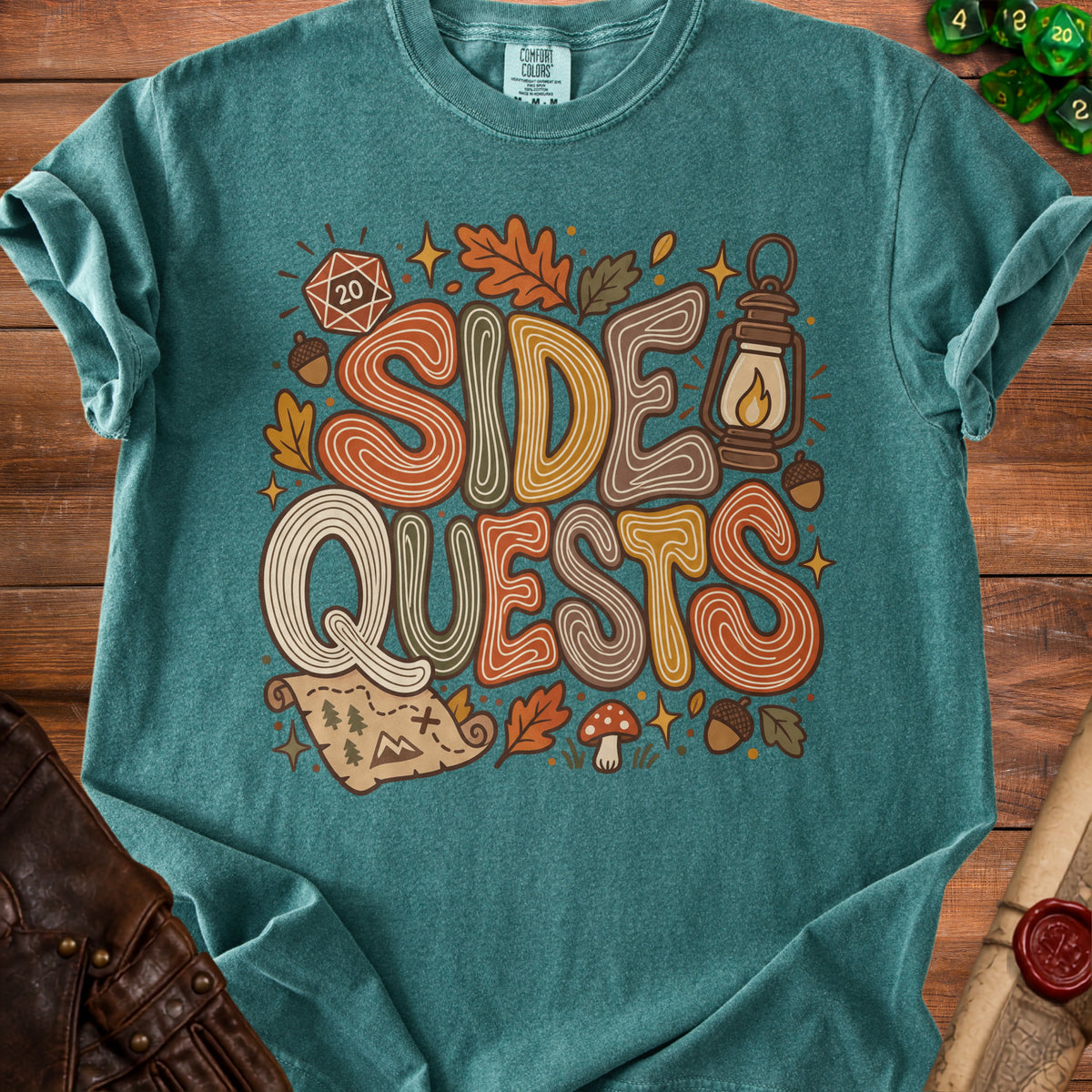 "Side Quests" graphic tee with dice, map, lantern, and autumn leaves.
