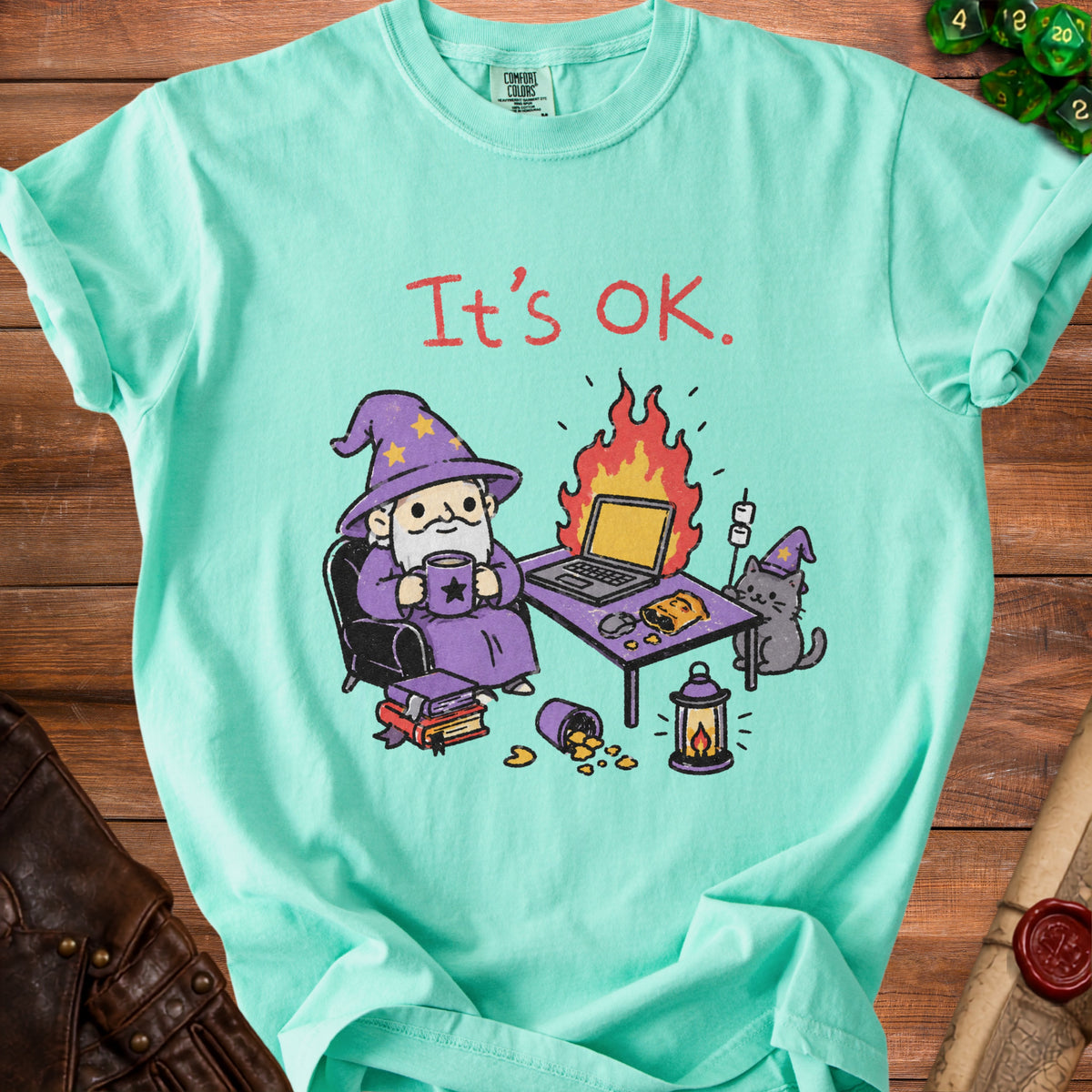 Mint t-shirt with "It's OK." text and cartoon wizard and cat.