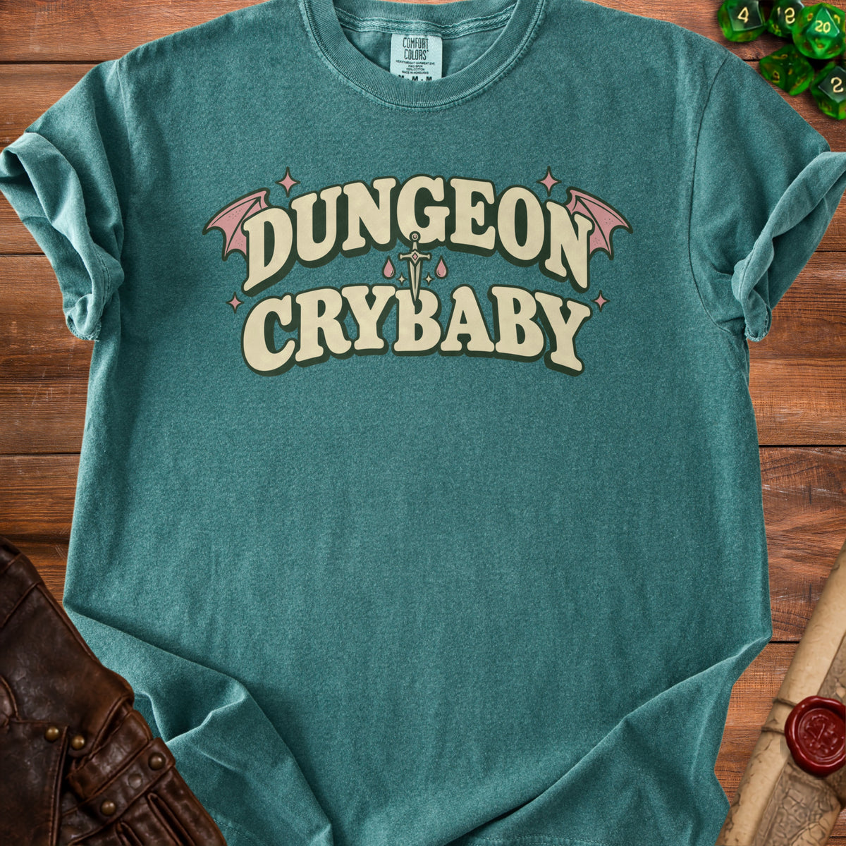 Teal t-shirt with "DUNGEON CRYBABY" text, sword, and bat wings.