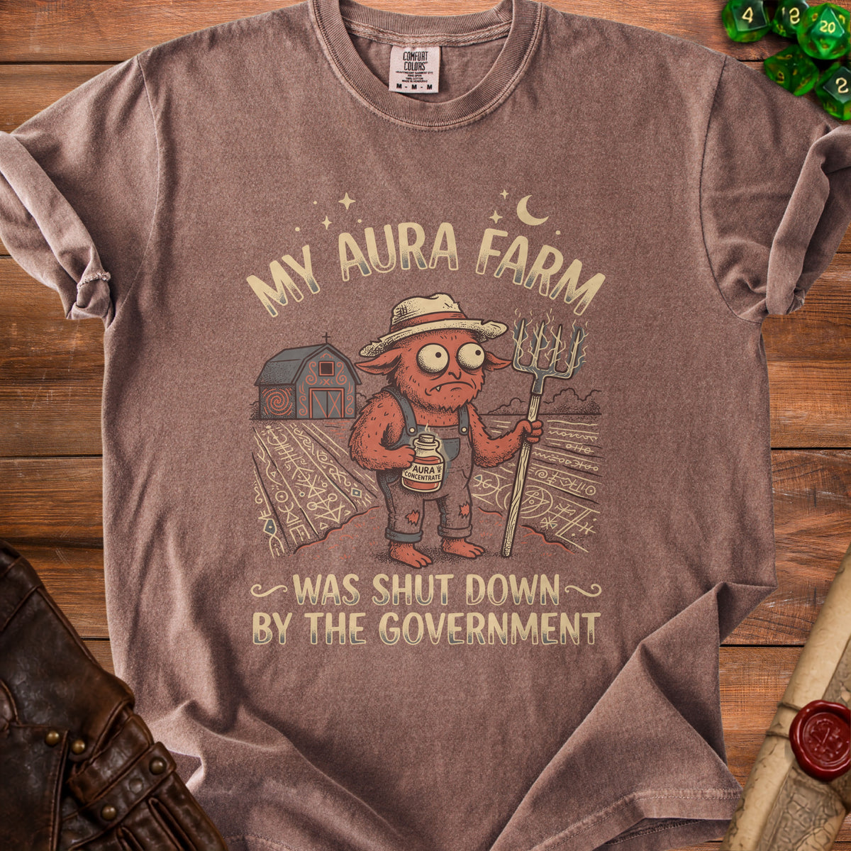 T-shirt with illustration of a creature and text "My Aura Farm Was Shut Down by the Government".