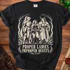 Black t-shirt with "Proper Ladies Improper Quests" text and fantasy art of three women.