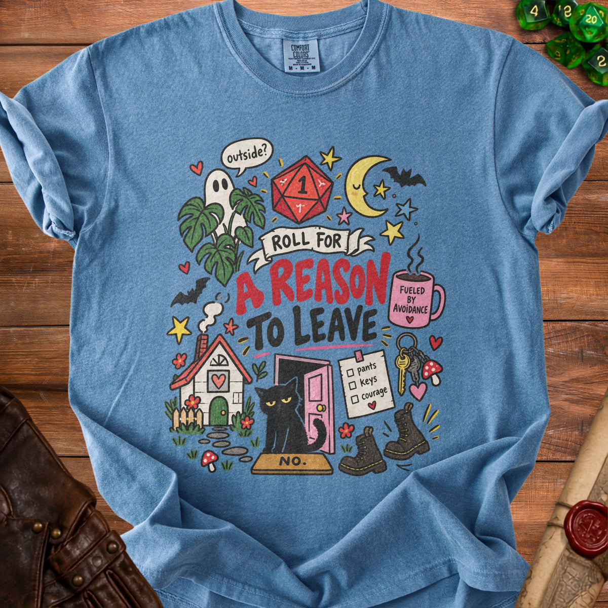 Blue t-shirt with "Roll for a Reason to Leave" graphic featuring a cat, dice, and house.