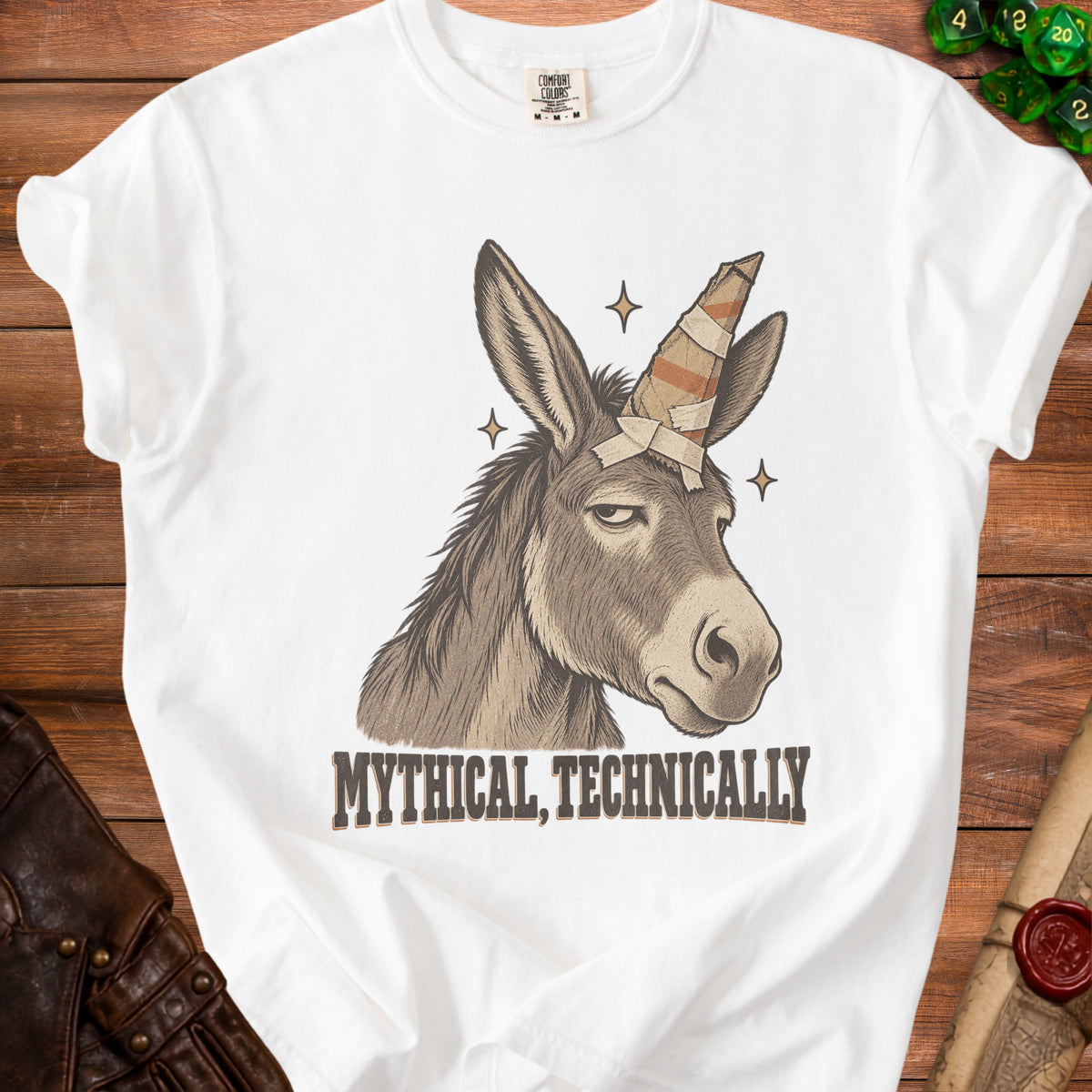 White t-shirt with a donkey wearing a bandage unicorn horn and text.