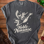 Dark grey t-shirt with a cream graphic of a frog flying on a goose, captioned "Noble Nonsense".