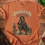 Orange crewneck t-shirt featuring a western graphic of a female adventurer and the text Dungeon Drifter.