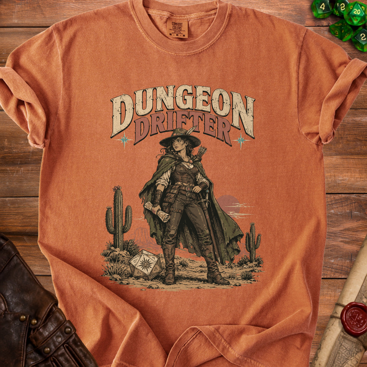 Orange crewneck t-shirt featuring a western graphic of a female adventurer and the text Dungeon Drifter.