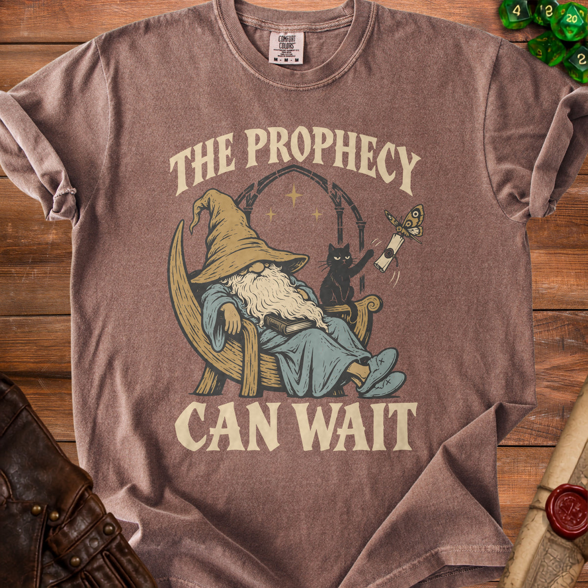Brown t-shirt with a wizard, black cat, and text reading "The Prophecy Can Wait".