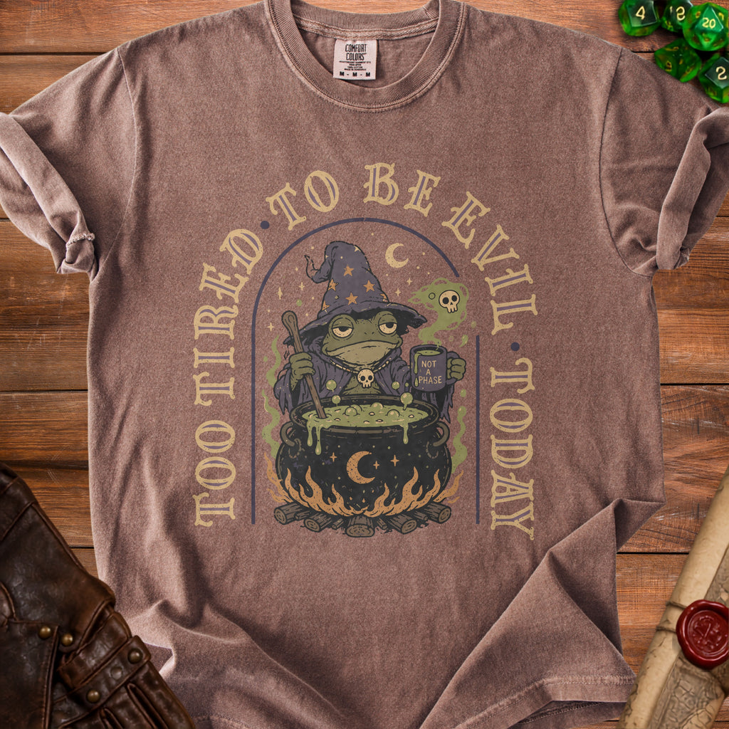 Brown t-shirt with a graphic of a tired frog wizard and text "Too Tired to Be Evil Today".