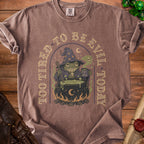 Brown t-shirt with a graphic of a tired frog wizard and text "Too Tired to Be Evil Today".