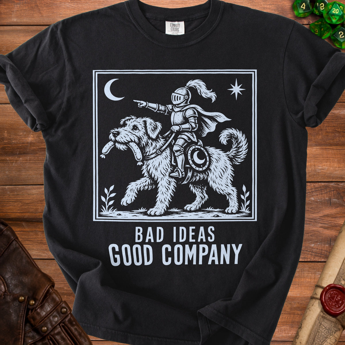Black t-shirt with white graphic of knight riding a dog, text "BAD IDEAS GOOD COMPANY".