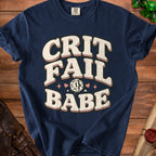 Dark blue t-shirt with "Crit Fail Babe" text and dice graphic.