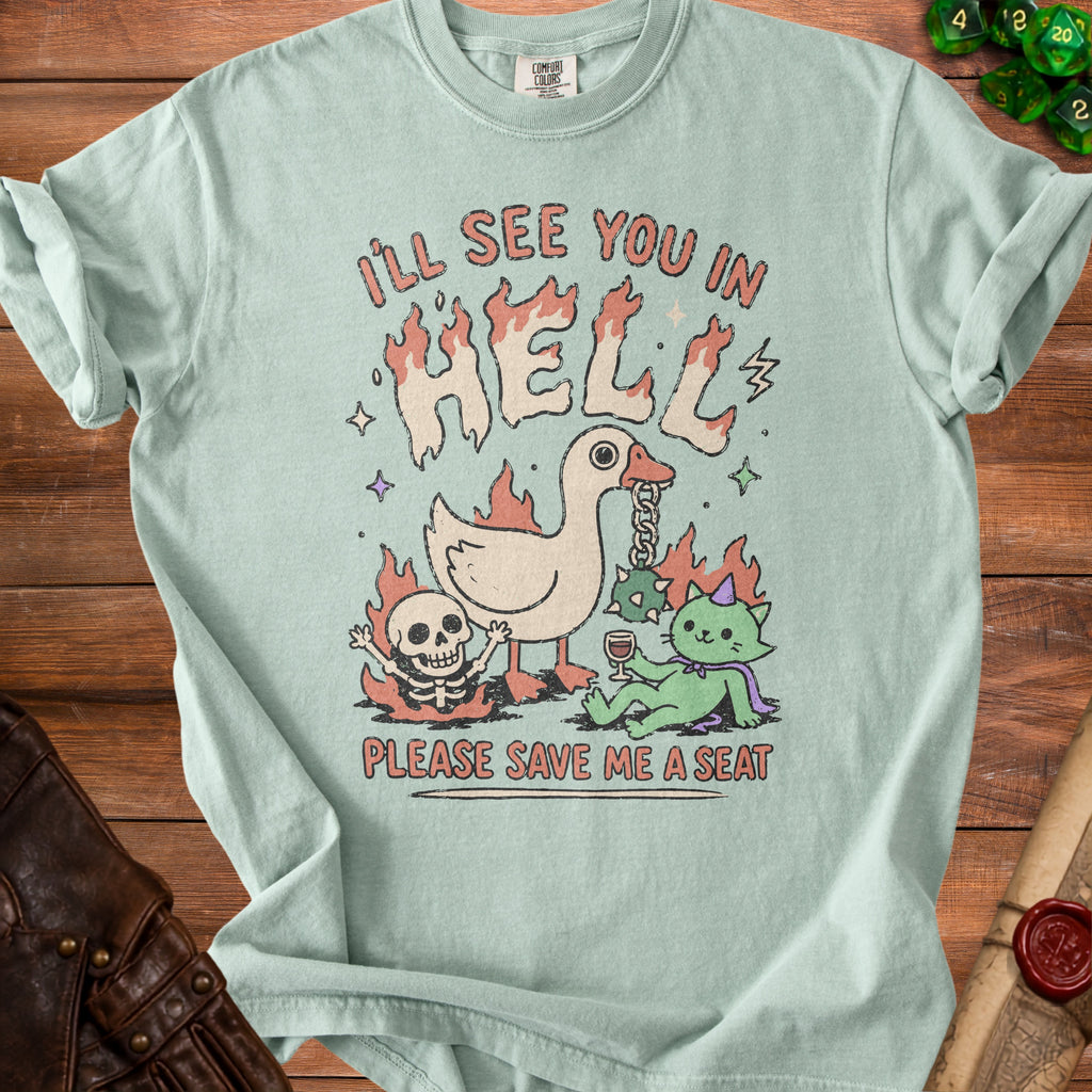 Light green t-shirt with "I'LL SEE YOU IN HELL" and "PLEASE SAVE ME A SEAT" text and cartoon graphics.
