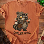 Raccoon in a hooded cloak holds coffee and a scroll with "Quest Log Closed."