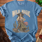 Blue t-shirt with a desert witch casting magic holding a 20-sided die.