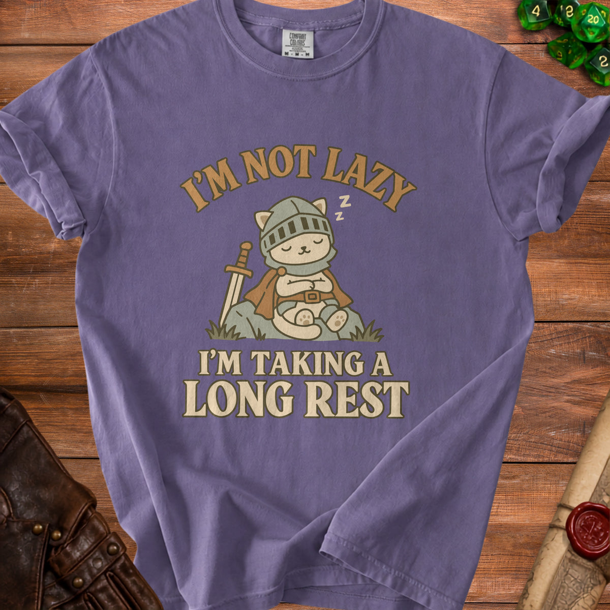 Purple t-shirt with a knight cat sleeping and the text "I'M NOT LAZY I'M TAKING A LONG REST".