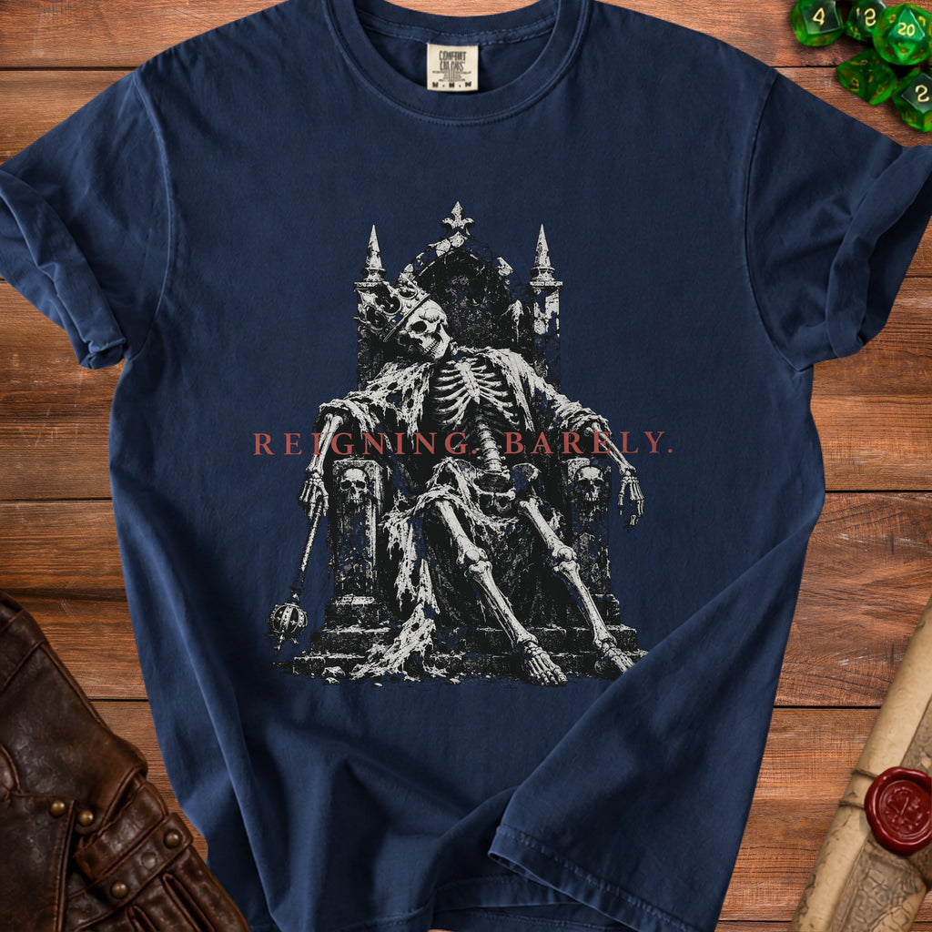 Dark blue t-shirt featuring skeleton king on throne with text "REIGNING BARNLY".