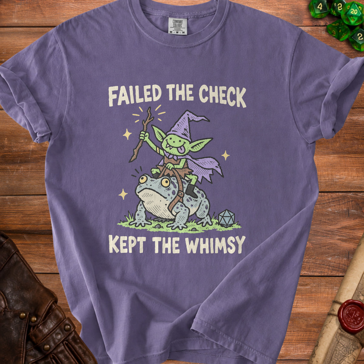 Purple t-shirt with a goblin riding a frog, reading "Failed the check kept the whimsy."