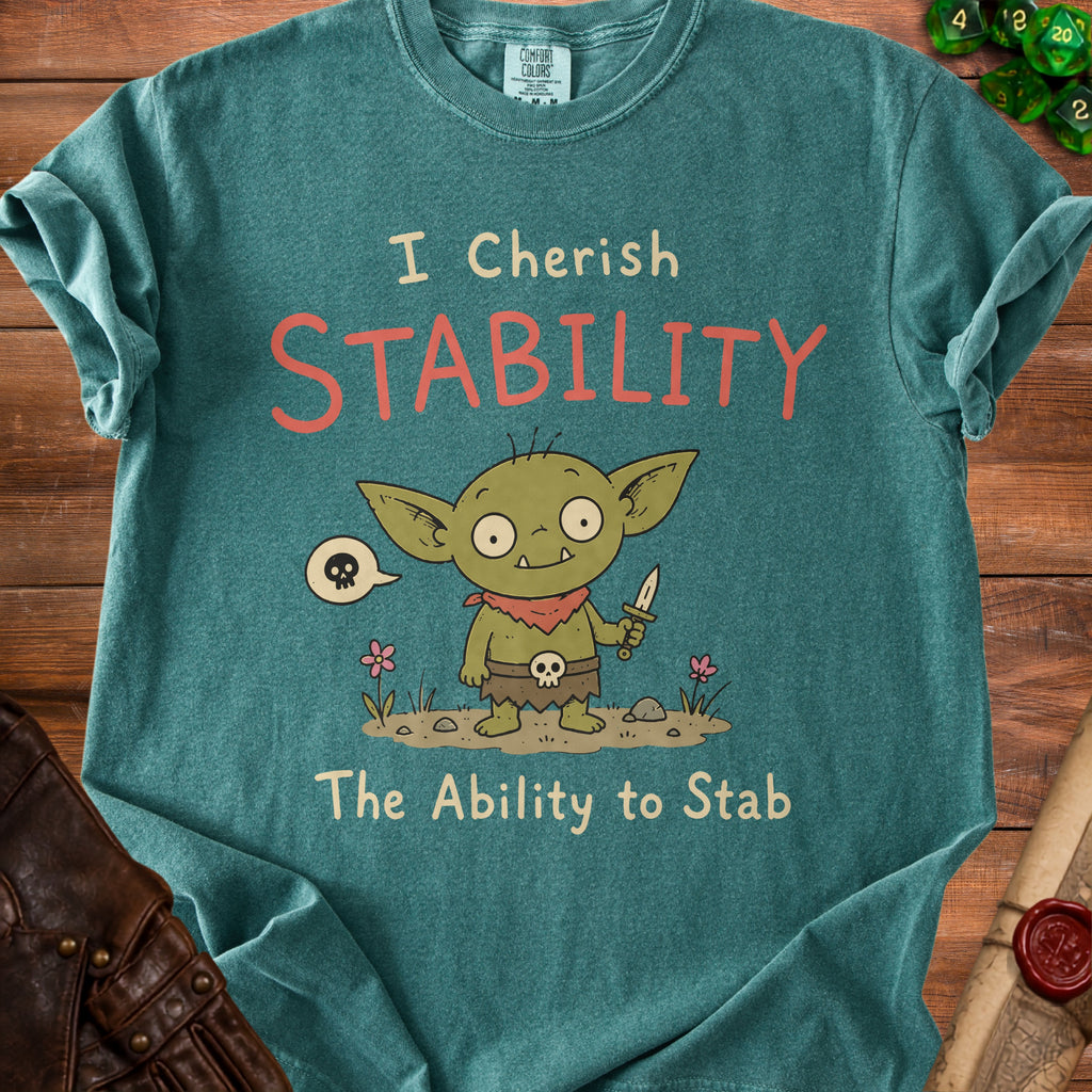 Green t-shirt with a cartoon goblin and the text "I Cherish STABILITY The Ability to Stab".